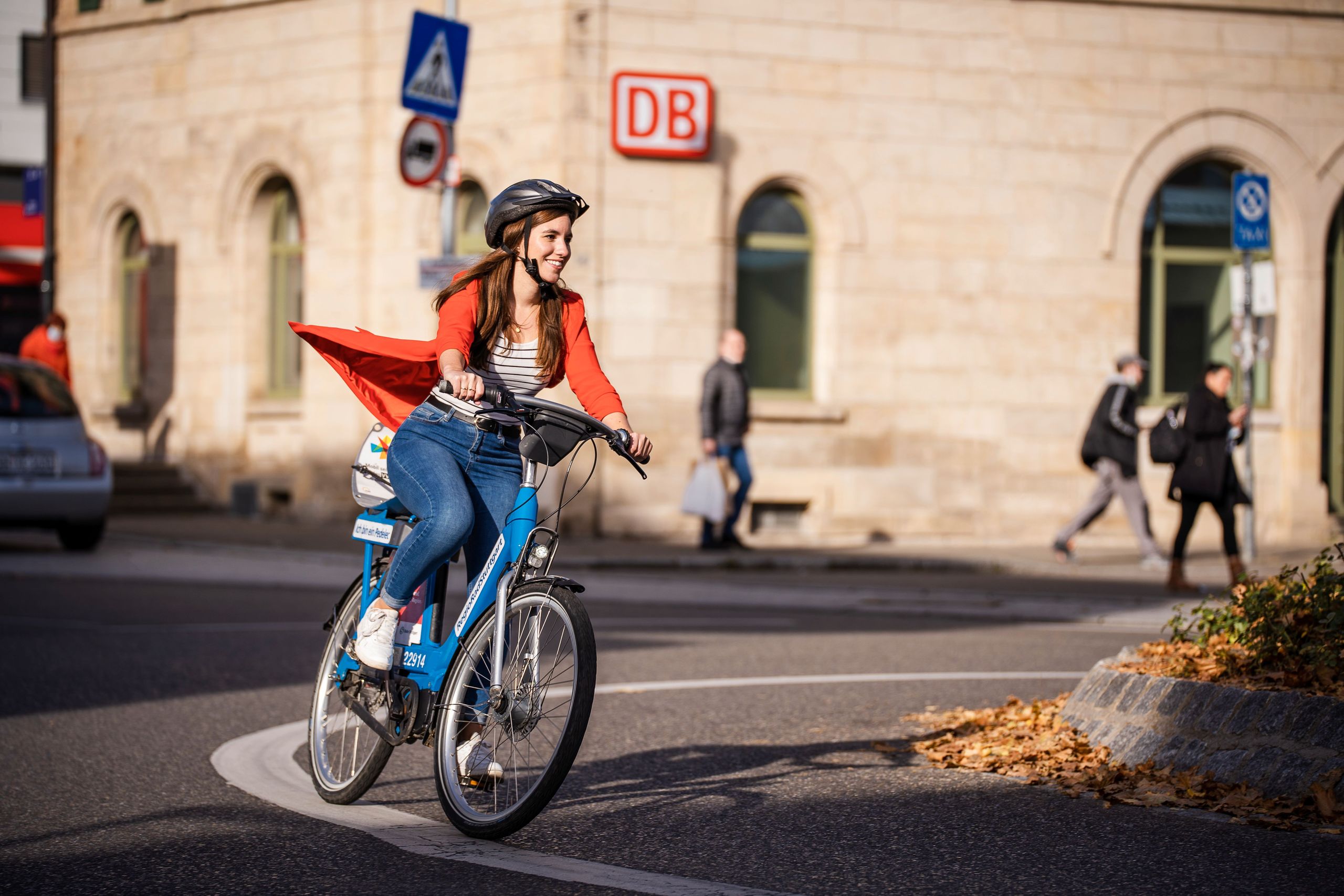 Frau fährt mit RegioRadStuttgart Pedelic auf der Straße am Bahnhof